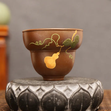 Golden Harvest: Yixing Zisha Teacup with Gourd Vine Motif