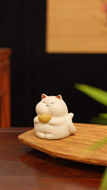 white cat holding gold handmade pottery figurine decor (tea pet) made by yixing purple clay