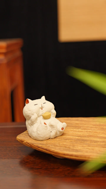 white cat holding gold handmade pottery figurine decor (tea pet) made by yixing purple clay