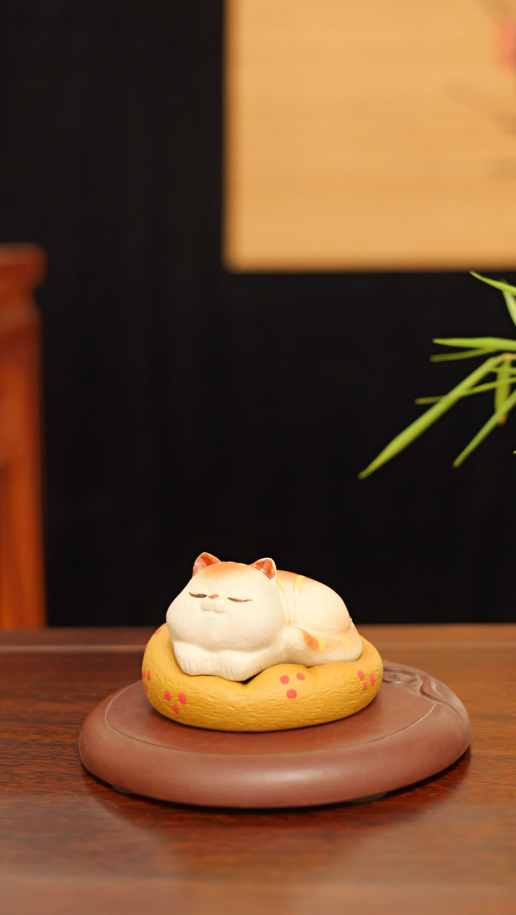A kitten curled up in its cat bed handmade pottery figurine decor (tea pet) made by yixing purple clay