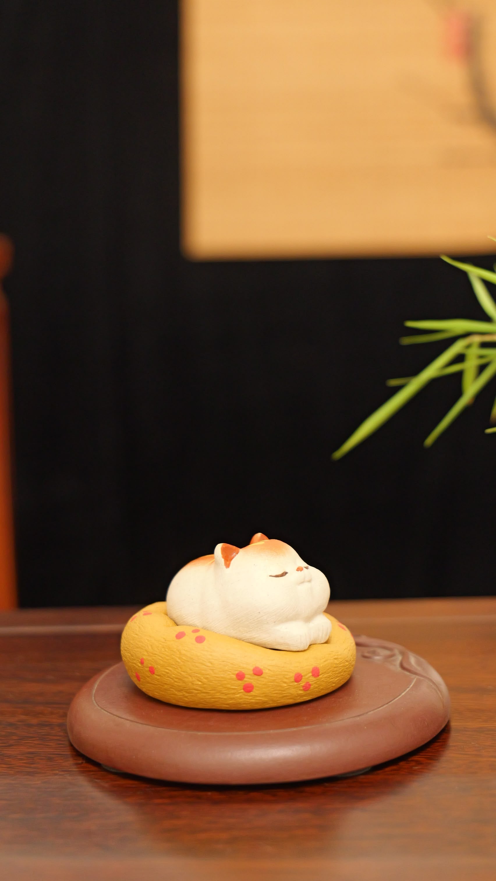 A kitten curled up in its cat bed handmade pottery figurine decor (tea pet) made by yixing purple clay