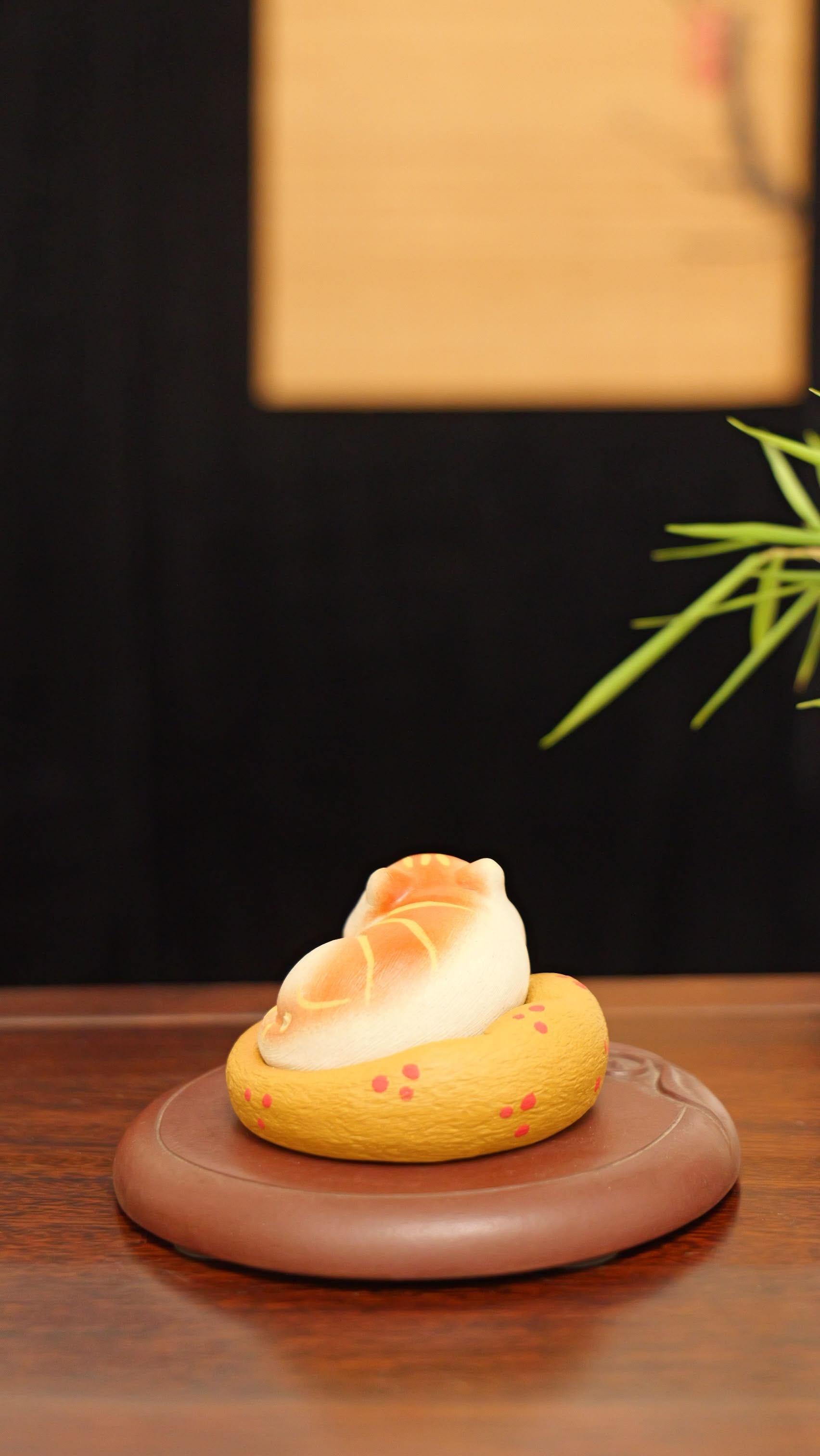 A kitten curled up in its cat bed handmade pottery figurine decor (tea pet) made by yixing purple clay