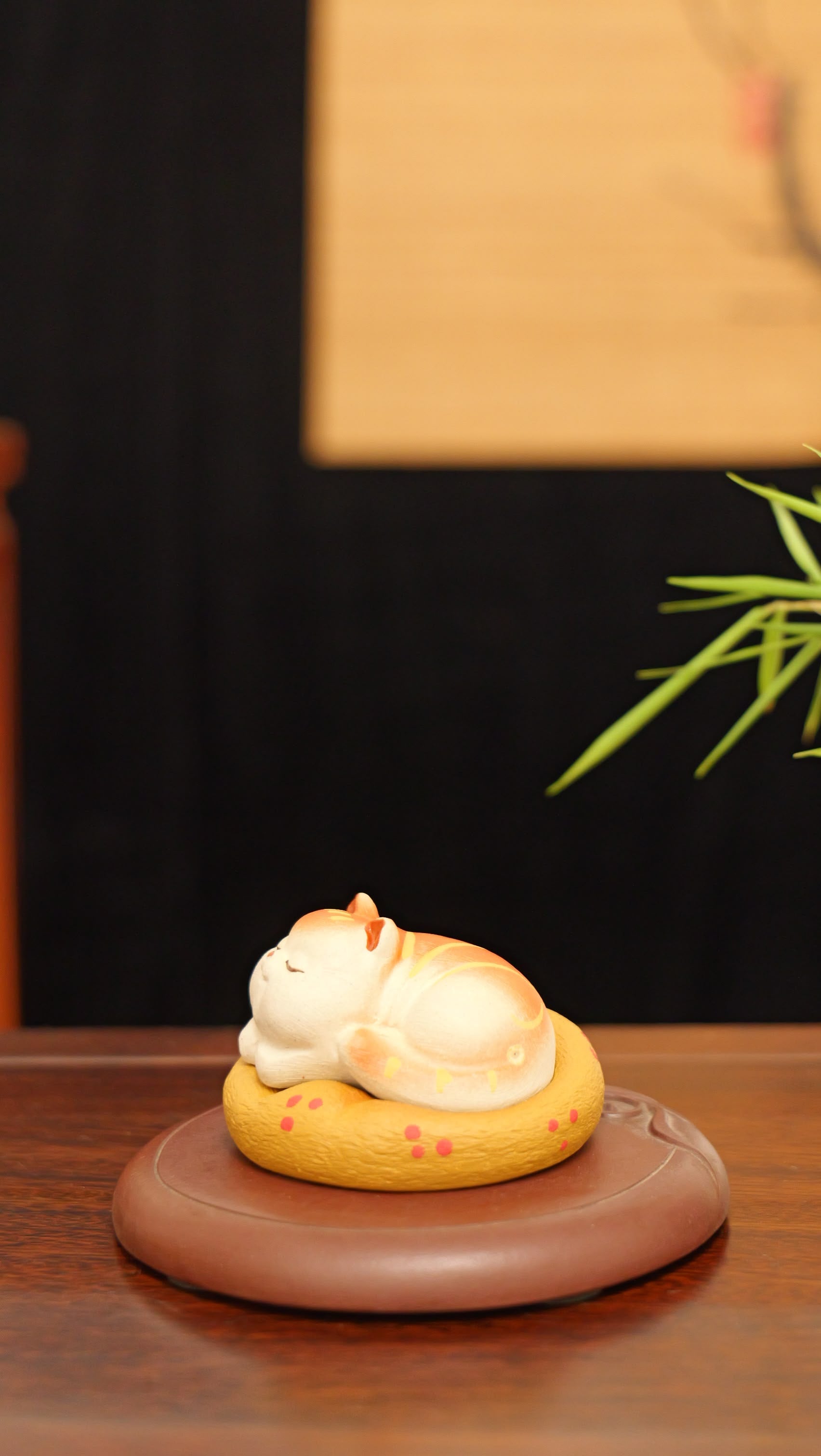 A kitten curled up in its cat bed handmade pottery figurine decor (tea pet) made by yixing purple clay