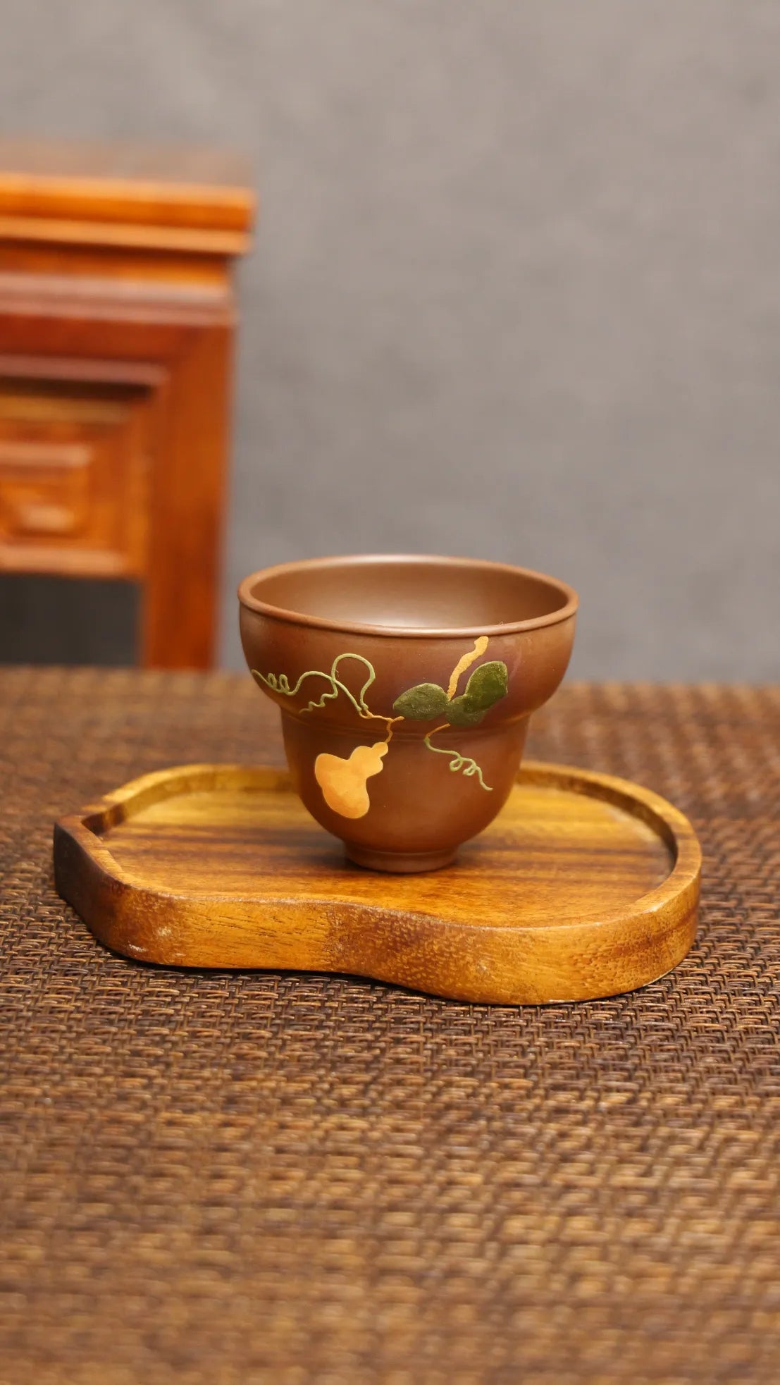 Golden Harvest: Yixing Zisha Teacup with Gourd Vine Motif