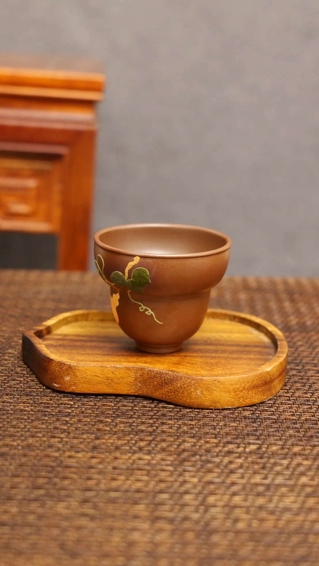 Golden Harvest: Yixing Zisha Teacup with Gourd Vine Motif
