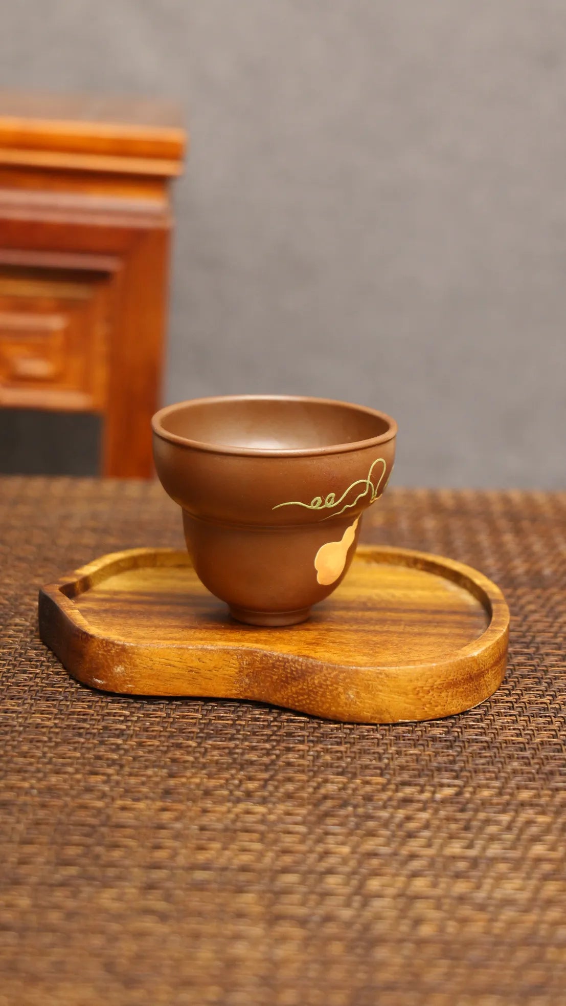Golden Harvest: Yixing Zisha Teacup with Gourd Vine Motif