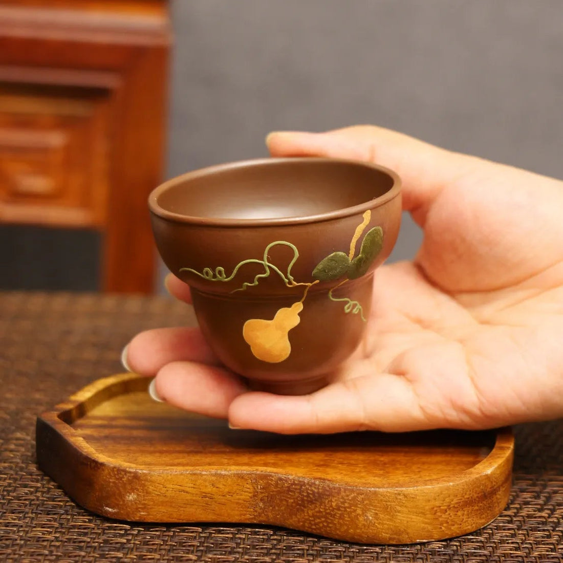 Golden Harvest: Yixing Zisha Teacup with Gourd Vine Motif
