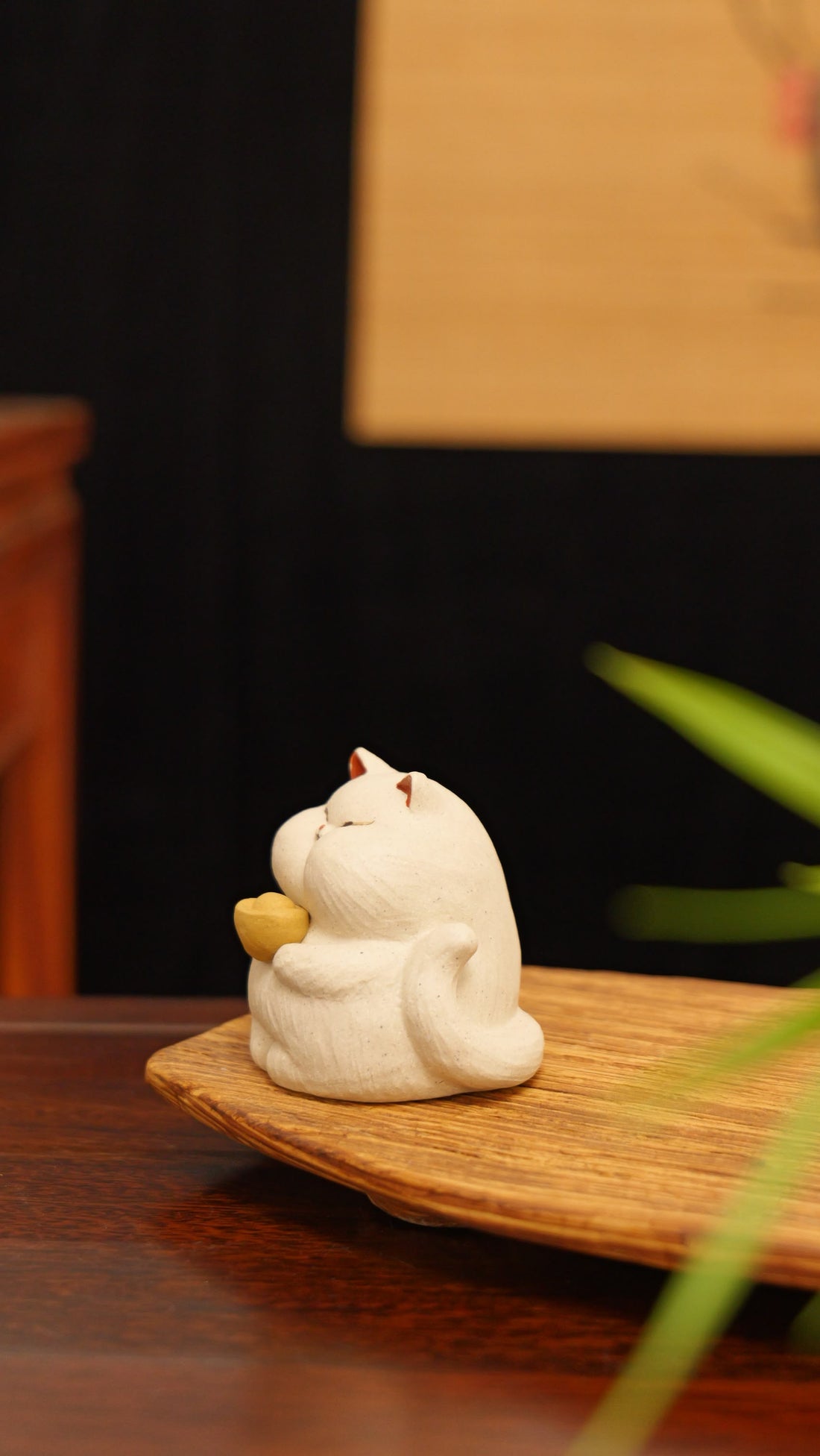 white cat holding gold handmade pottery figurine decor (tea pet) made by yixing purple clay