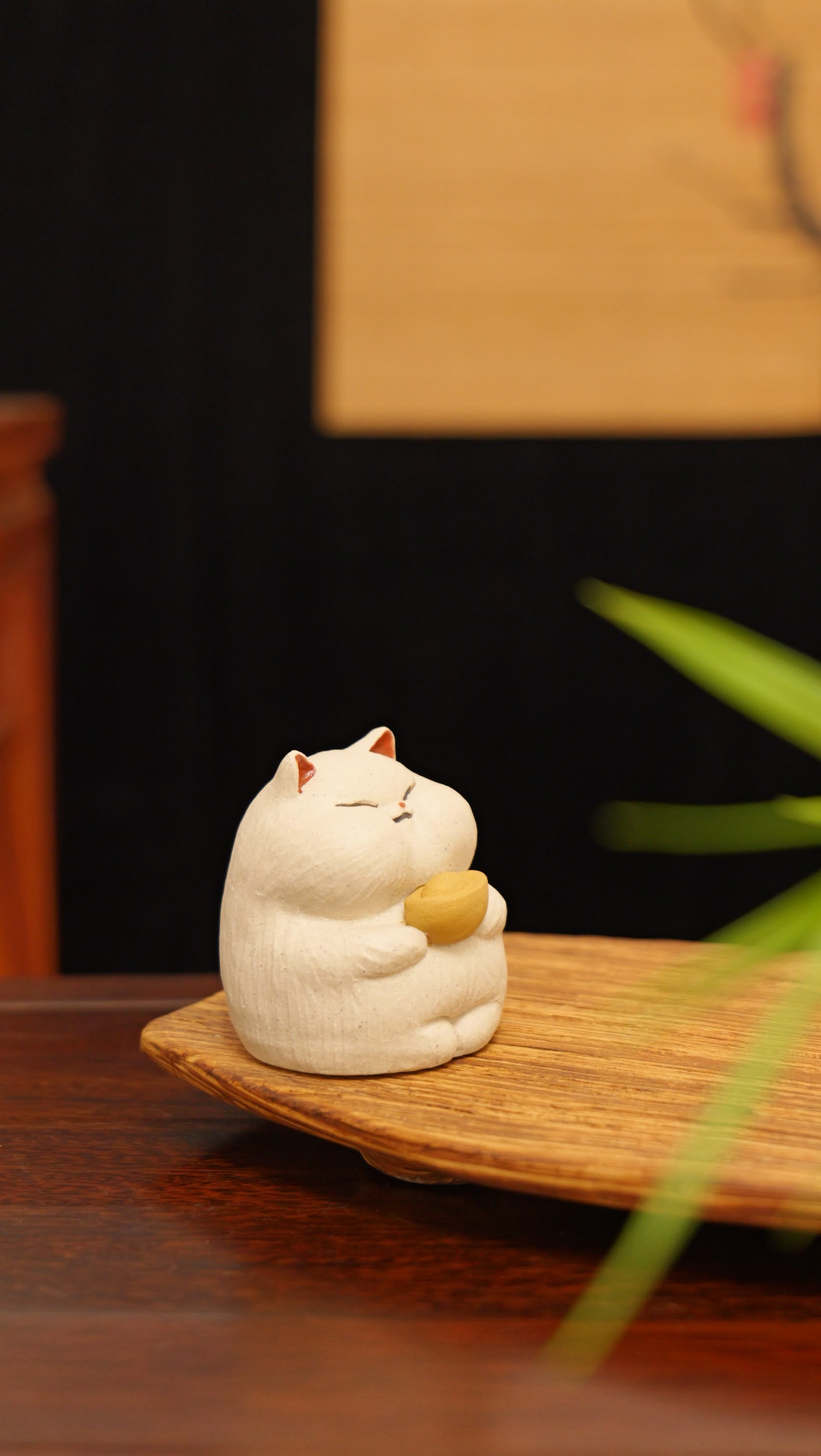 white cat holding gold handmade pottery figurine decor (tea pet) made by yixing purple clay