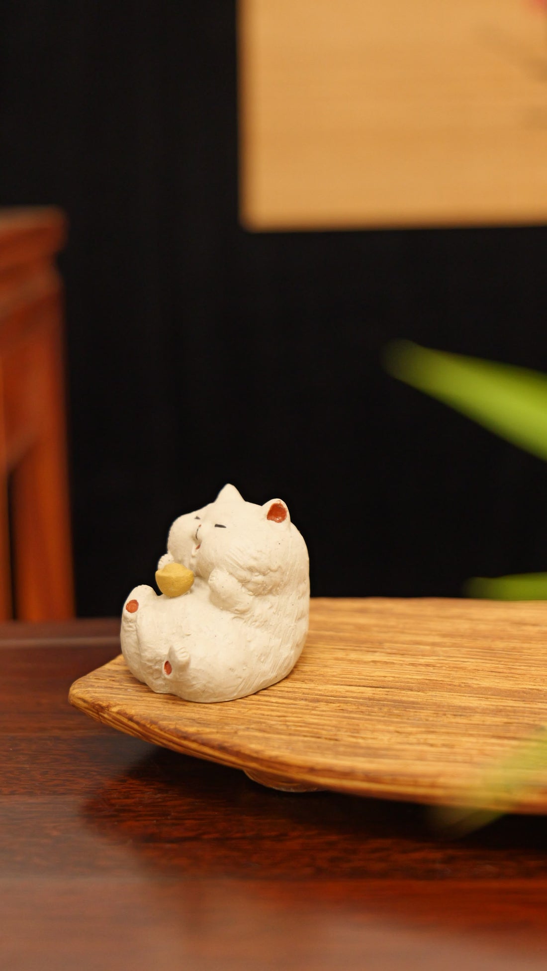 white cat holding gold handmade pottery figurine decor (tea pet) made by yixing purple clay