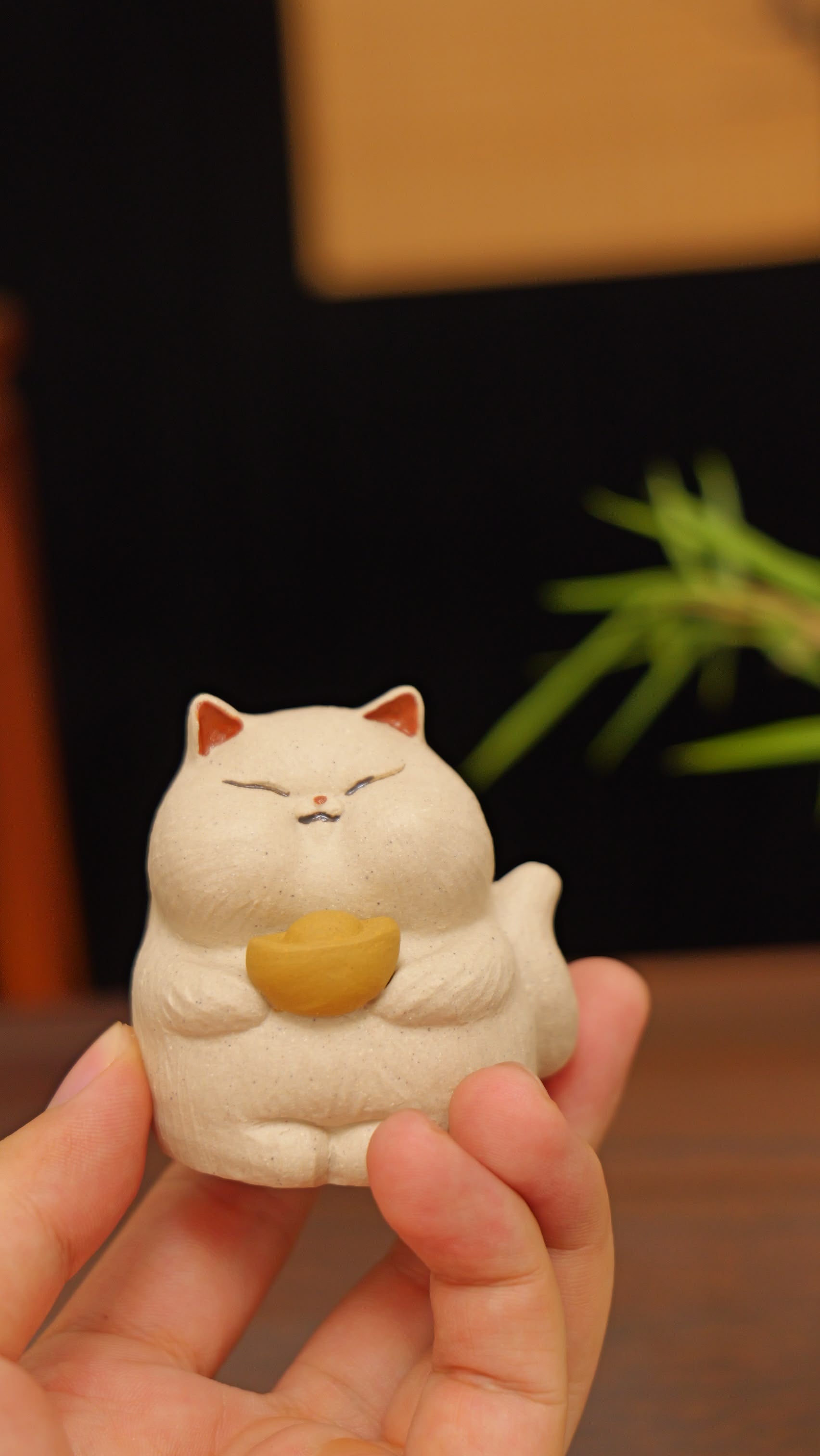 white cat holding gold handmade pottery figurine decor (tea pet) made by yixing purple clay