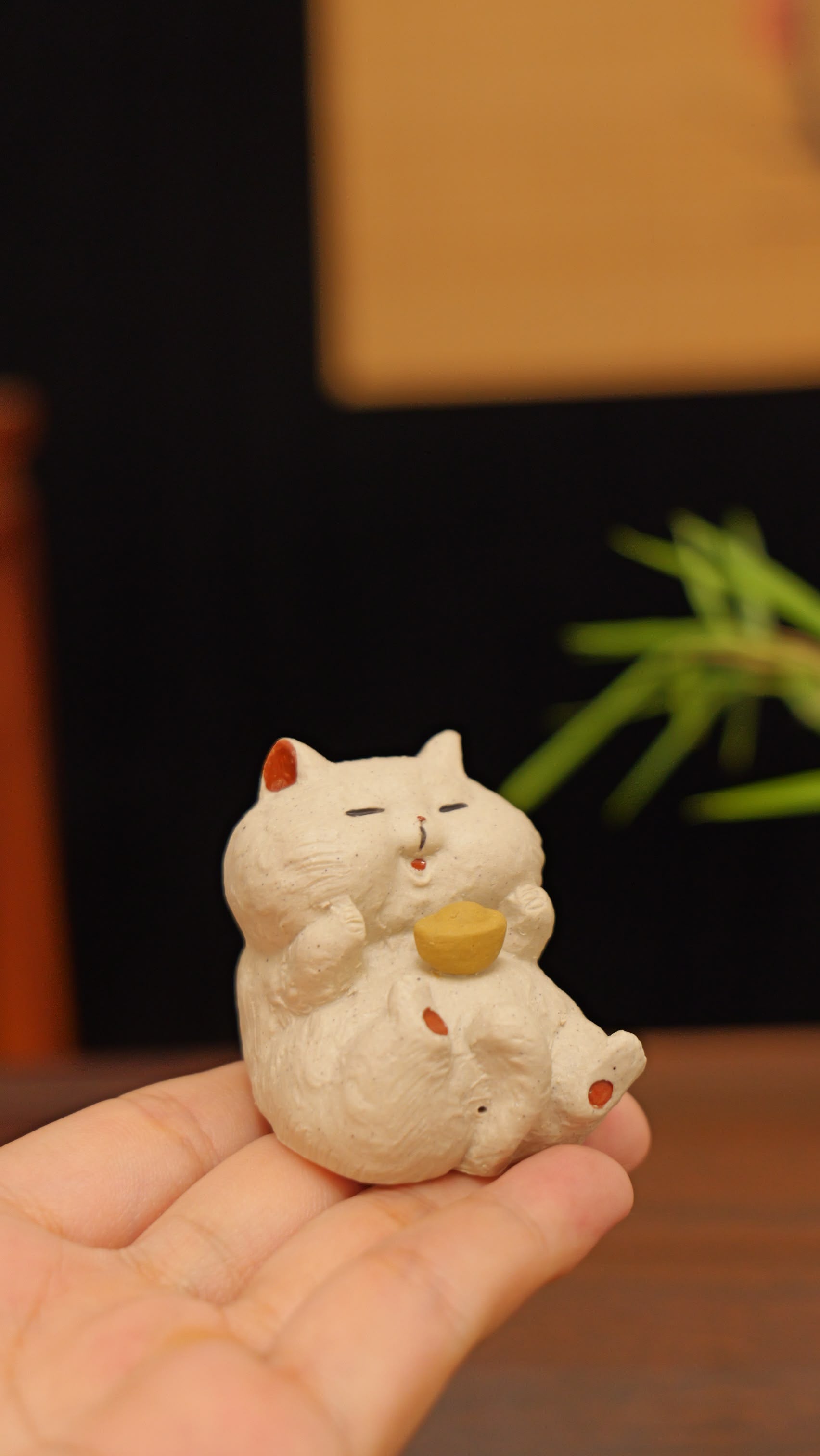 white cat holding gold handmade pottery figurine decor (tea pet) made by yixing purple clay