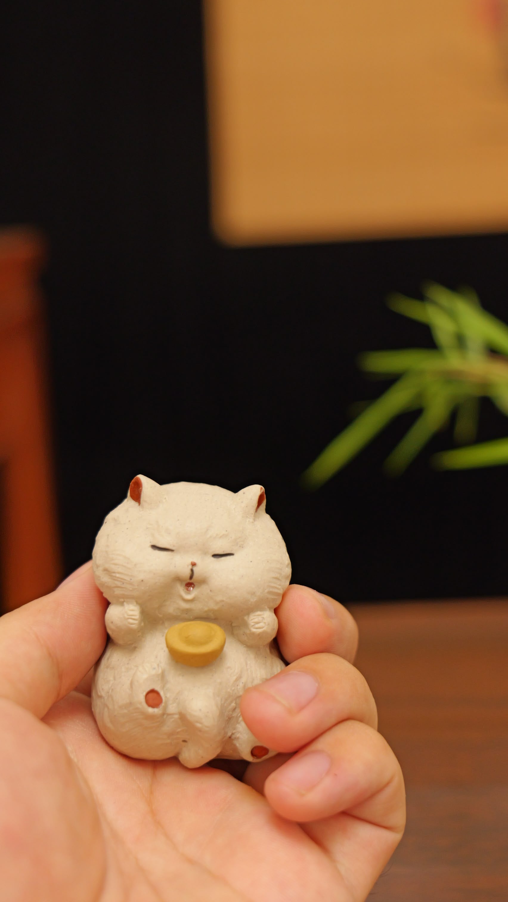 white cat holding gold handmade pottery figurine decor (tea pet) made by yixing purple clay