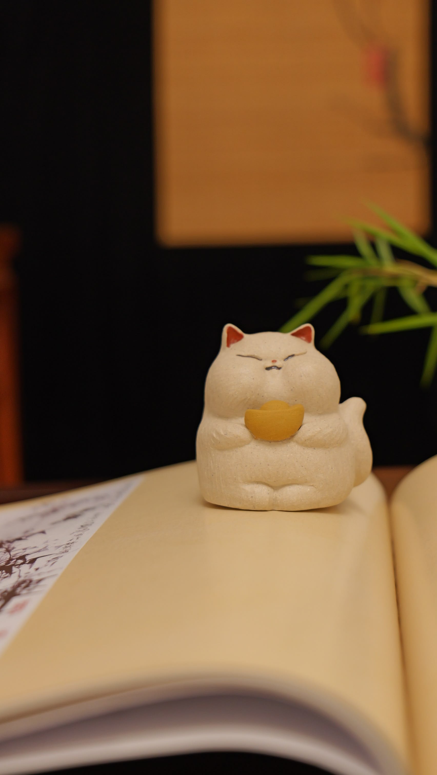 white cat holding gold handmade pottery figurine decor (tea pet) made by yixing purple clay