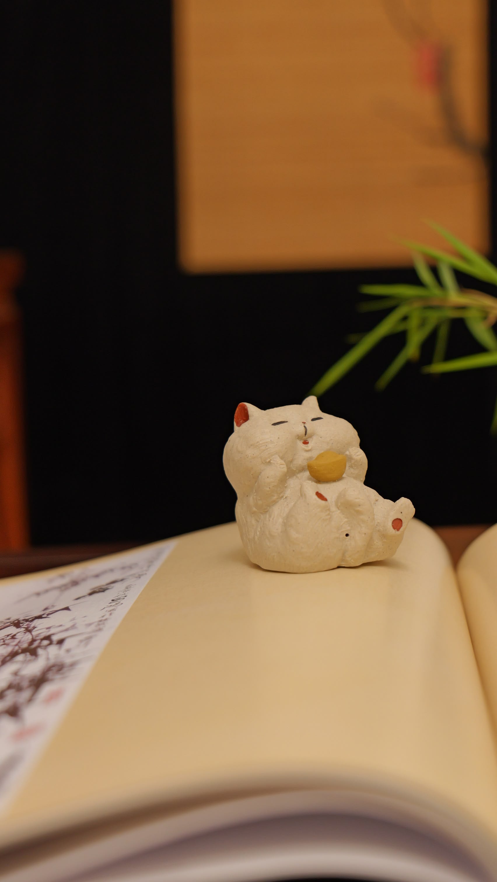 white cat holding gold handmade pottery figurine decor (tea pet) made by yixing purple clay